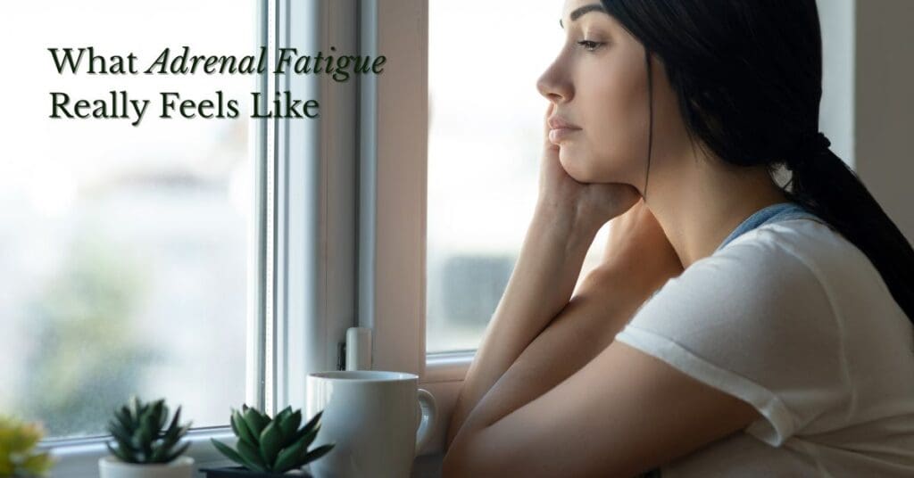 tired woman staring out a window wondering how do you know if you have adrenal fatigue.